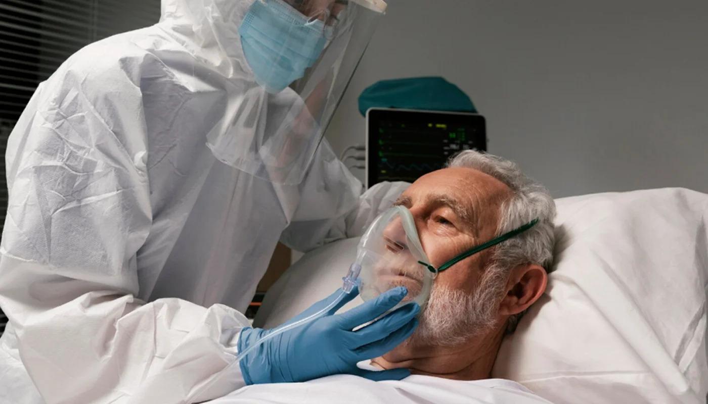 Healthcare worker putting an oxygen mask on an elderly patient